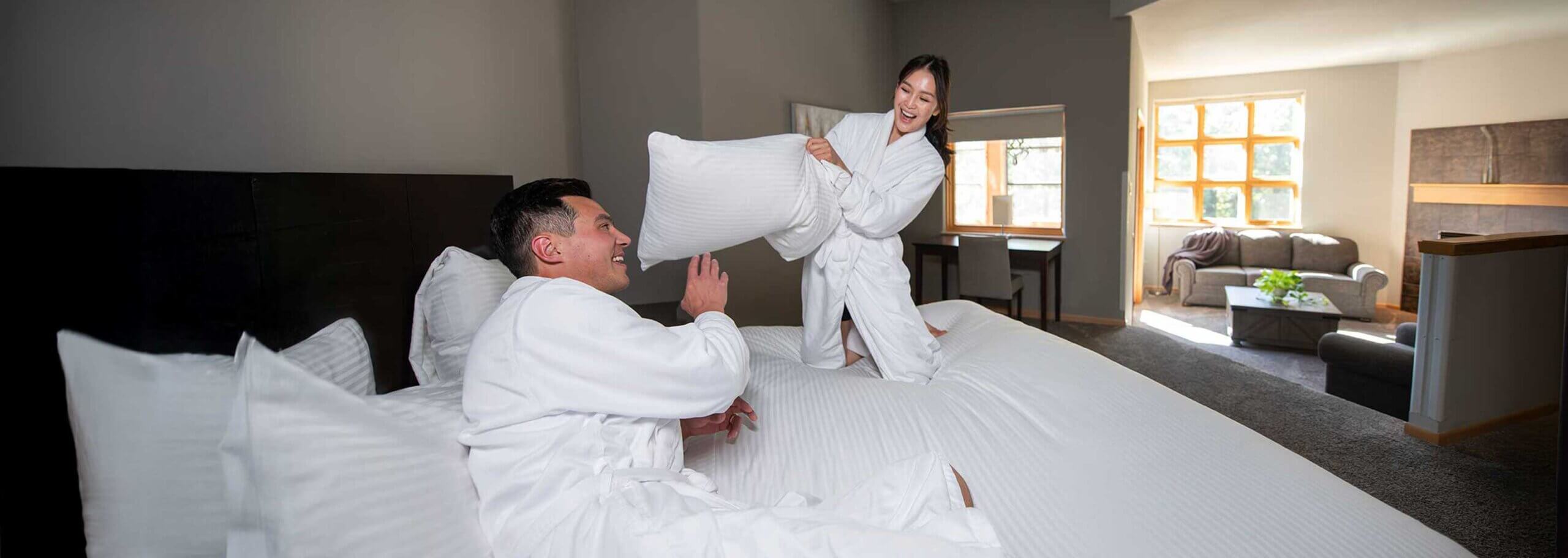 Couple in suite - fun little pillow fight